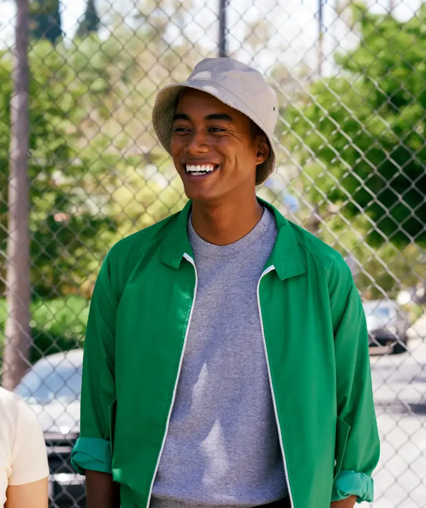 Young man and female friend by park fence los ang 2025 04 04 00 32 11 utc